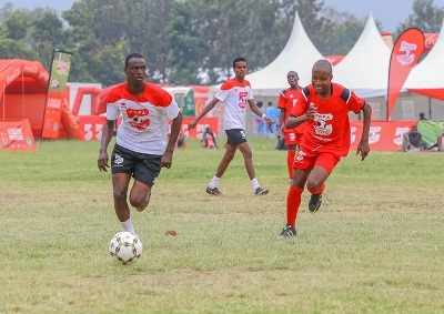 Bill Clinton of Agoro Sare boys (L) runs with the ball past  Abdiraham Dajib of Boys Town in the the Copa Coca cola under boys 16 National Finals Tournament 2019 at Kisumu National Polytechnic Kisumu.